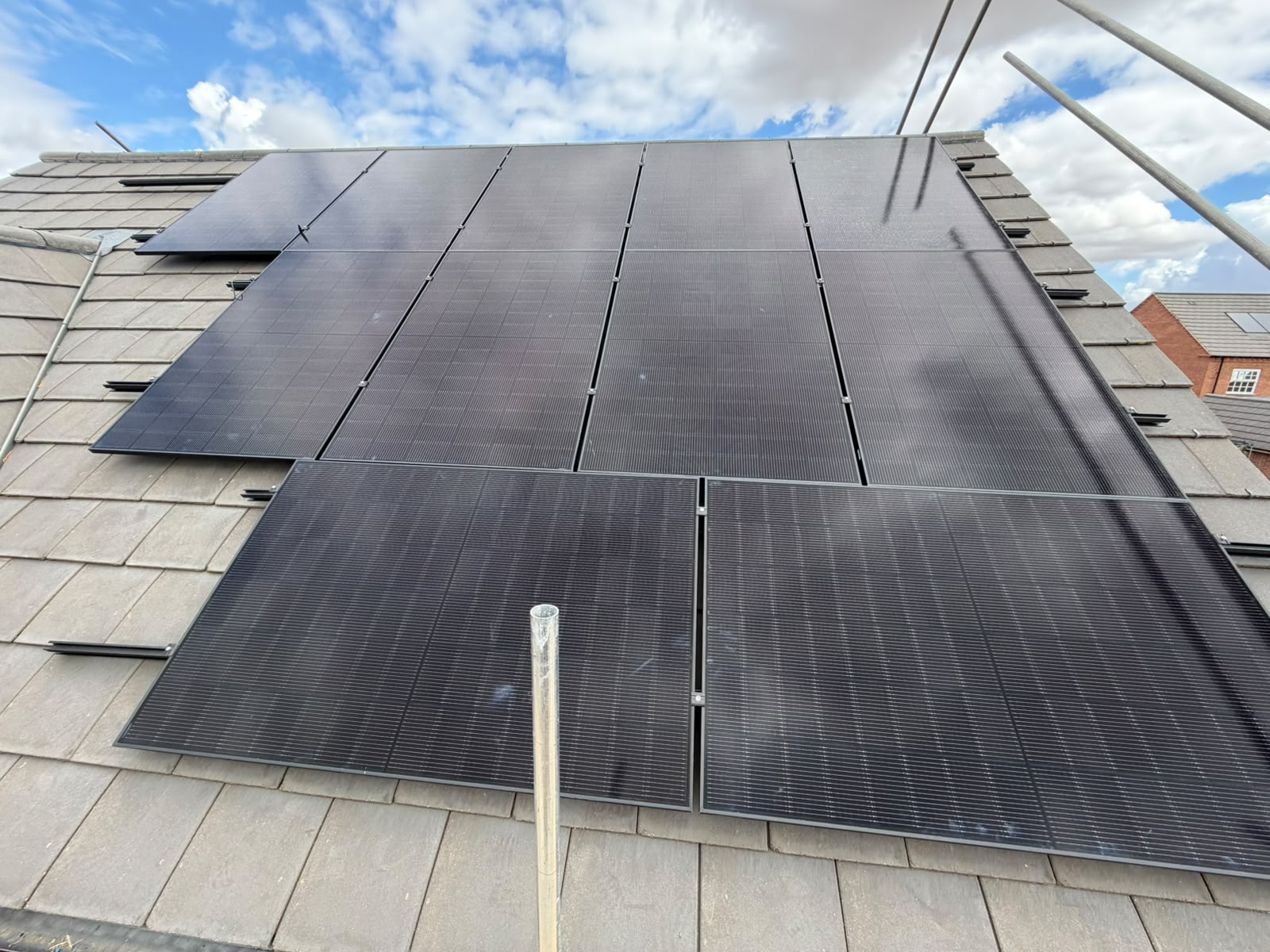 Solar panels covering the rear roof of a detached house in Hanslope