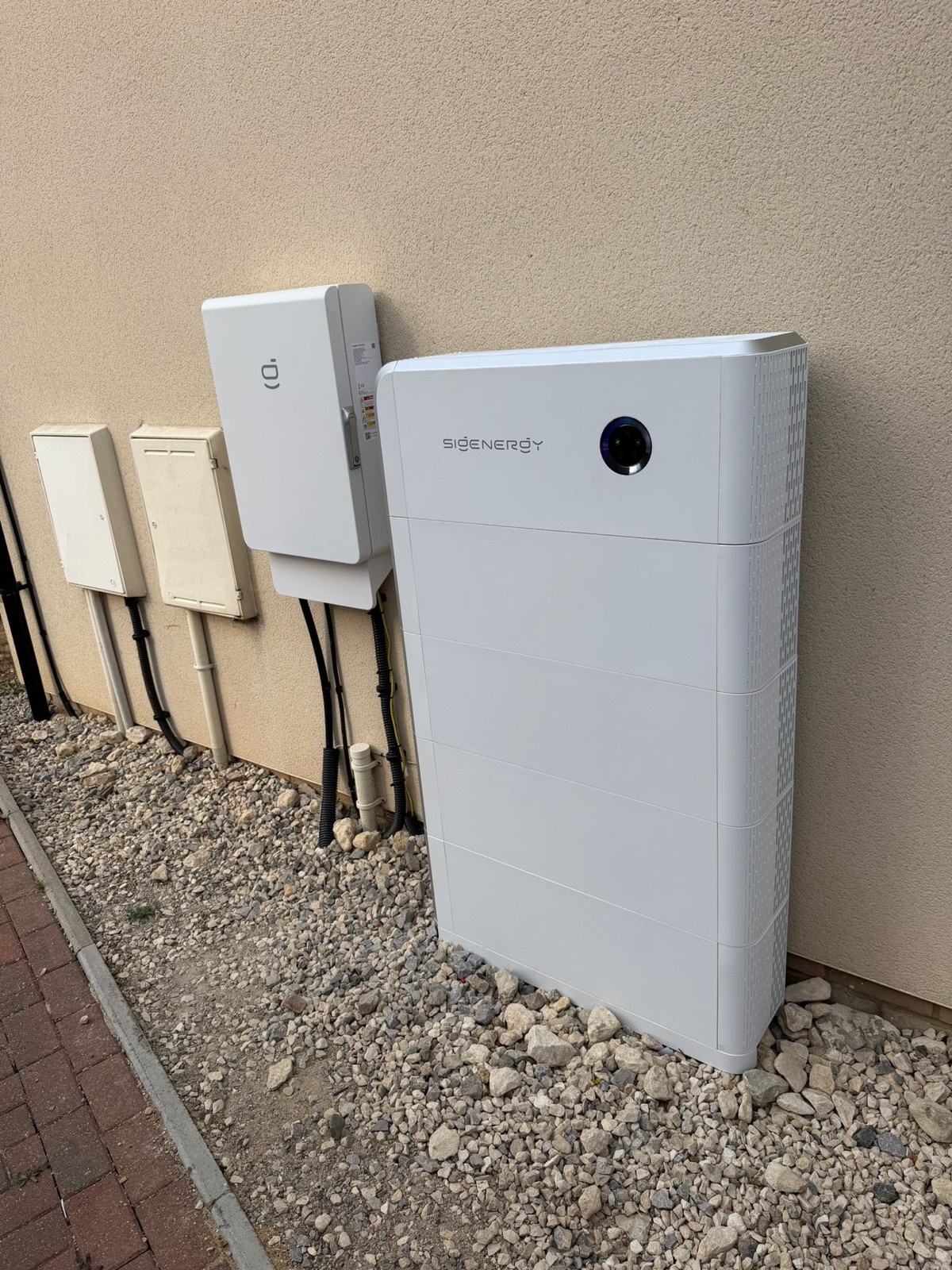 Sigenergy SigenStor inverter and battery units installed outside a house