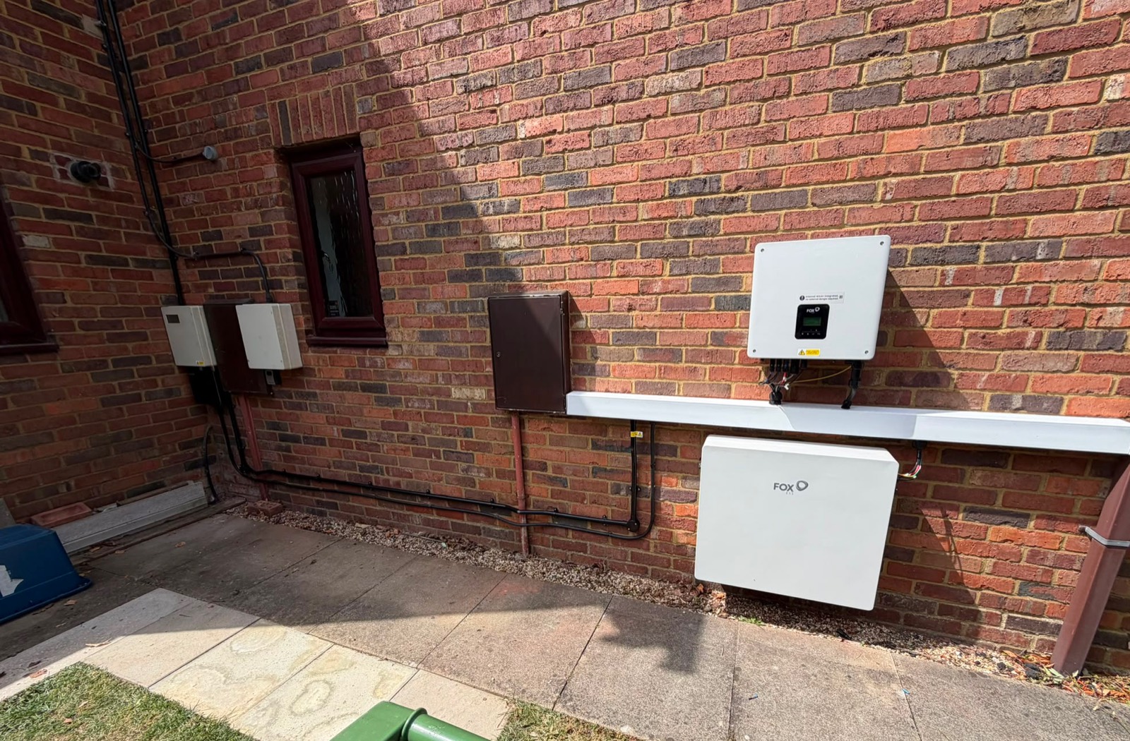 A Fox ESS hybrid inverter and battery fitted beside an older solar installation in Milton Keynes
