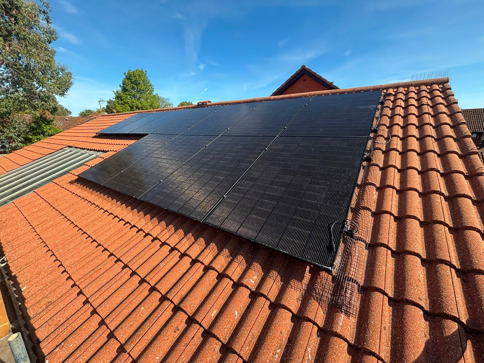 Black solar panels on a south-west facing tiled roof in Milton Keynes
