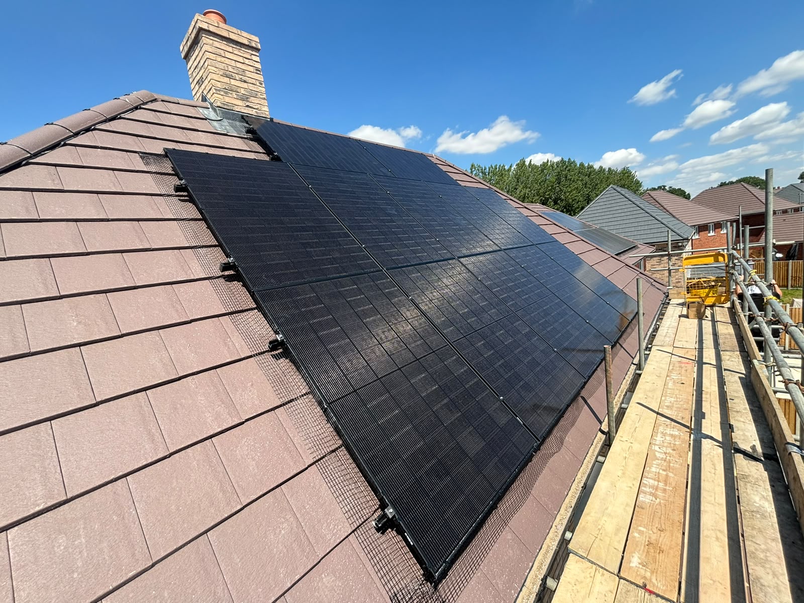 Twelve all-black solar panels on the south-facing roof of a new-build detached house in Woburn Sands