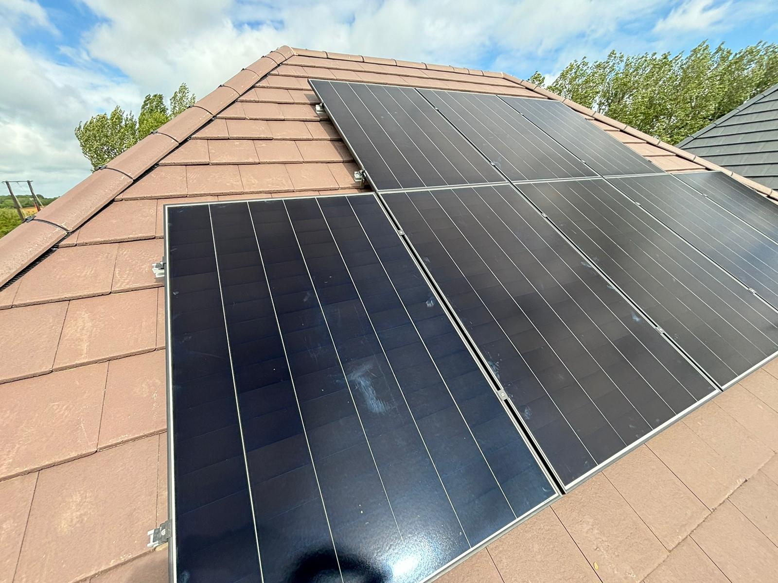 All-black solar panels on the south-facing rear roof of a new-build house in Woburn Sands