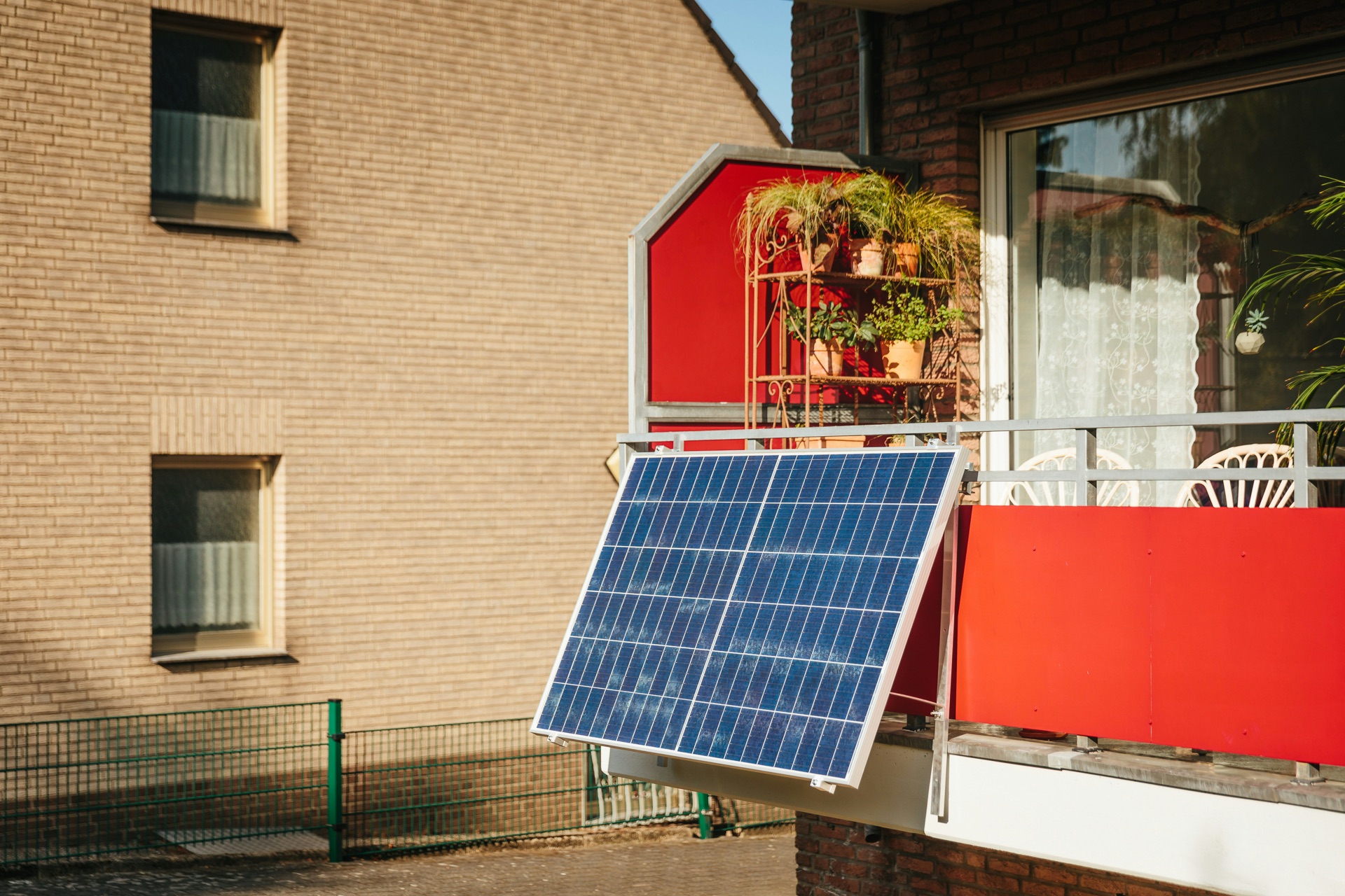 UK balcony with 2-3 solar panels mounted on railing