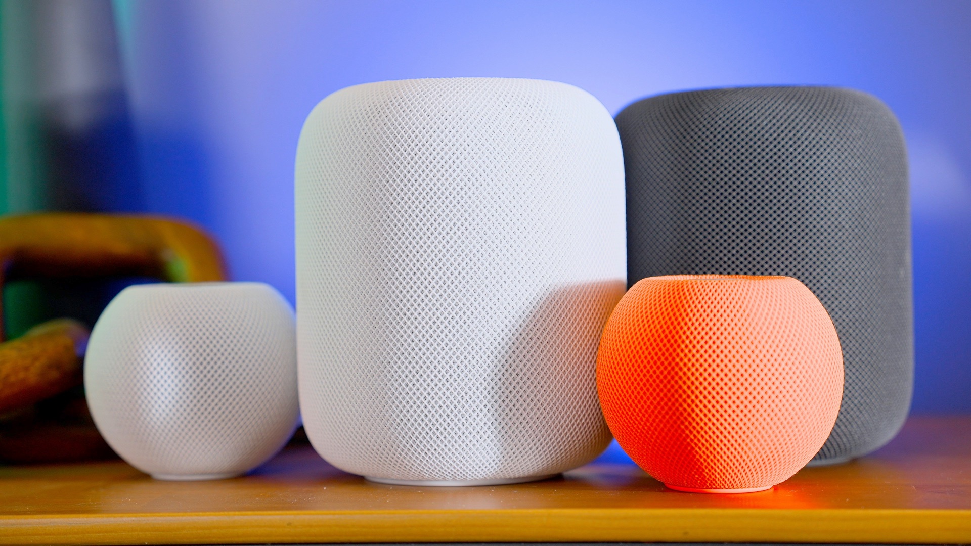 Apple HomePod and HomePod mini speakers in white, grey and orange