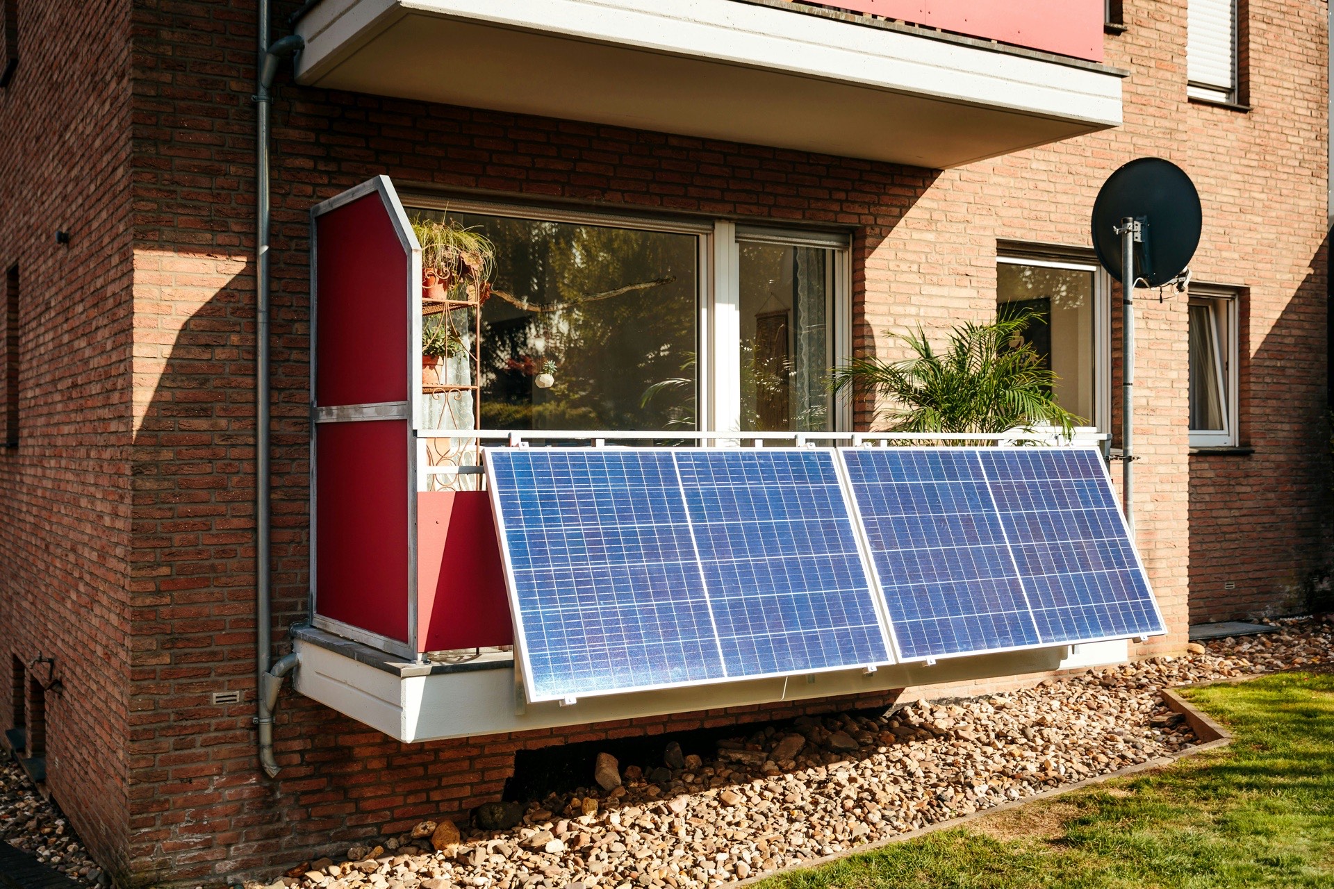 Larger balcony with multiple solar panels mounted on the railing